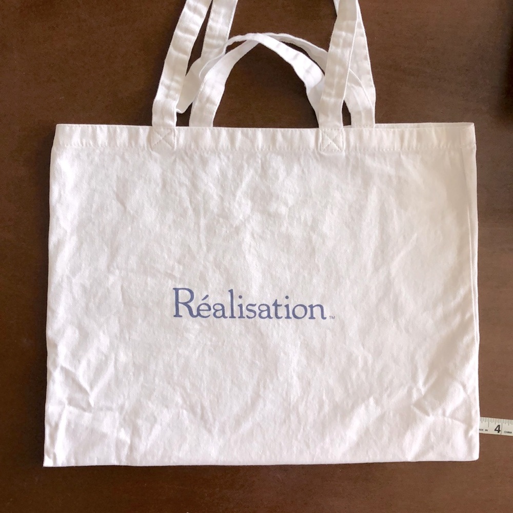 Realisation Par Canvas Tote Bag with Blue Text
